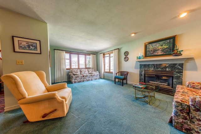 carpeted living room with recessed lighting, baseboards, and a fireplace
