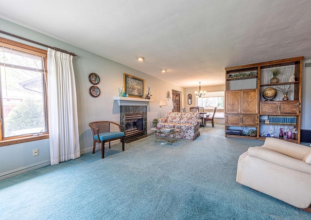 living room with an inviting chandelier, a fireplace, carpet flooring, and baseboards