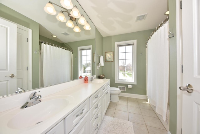 full bath with a sink, baseboards, and visible vents