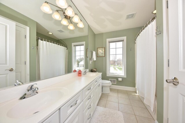 full bath with a sink, baseboards, and visible vents