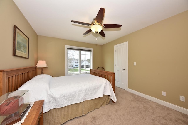 carpeted bedroom featuring baseboards and ceiling fan
