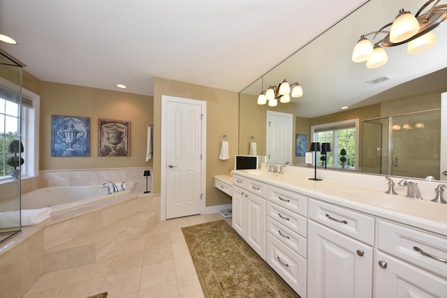 full bath with a sink, tile patterned flooring, a shower stall, and visible vents