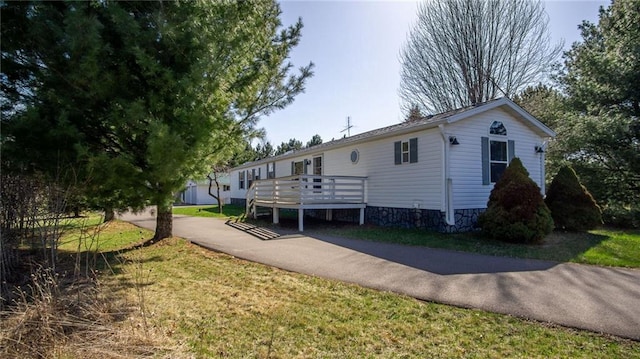 23603 69th Ave, Cadott, WI 54727 - exterior space with a front yard and a wooden deck