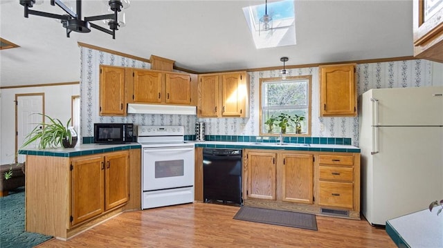 23603 69th Ave, Cadott, WI 54727 - kitchen featuring a sink, under cabinet range hood, crown molding, black appliances, and wallpapered walls