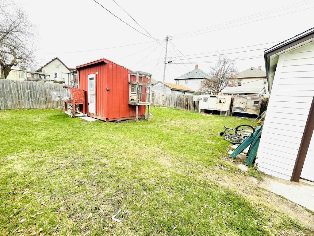 view of yard featuring an outdoor structure and a fenced backyard