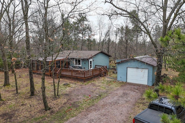 996 Inverness Ct, Nekoosa, WI 54457 - view of front of house featuring an outdoor structure, a wooden deck, driveway, and a garage