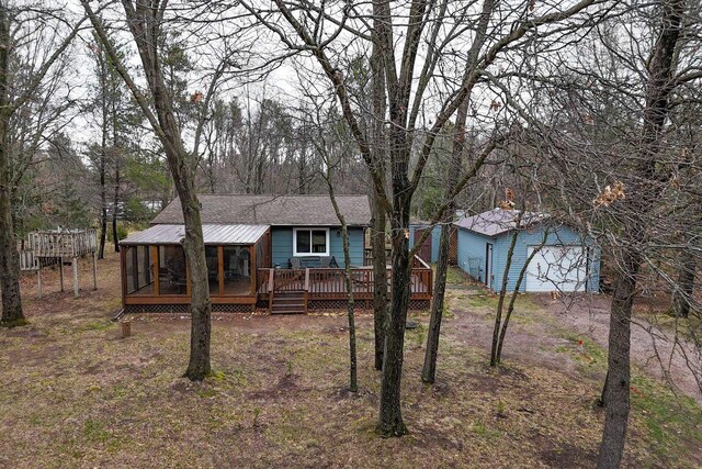 996 Inverness Ct, Nekoosa, WI 54457 - view of front of property featuring a deck, an outdoor structure, a sunroom, and a garage