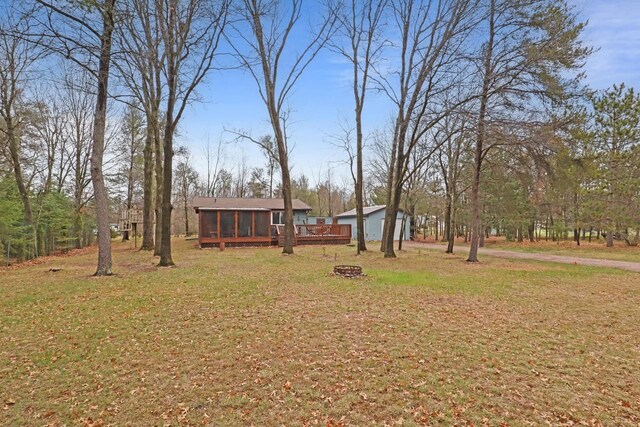 996 Inverness Ct, Nekoosa, WI 54457 - view of green lawn with a sunroom and an outdoor fire pit