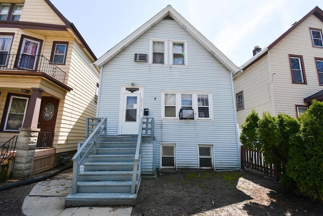 rear view of property with fence