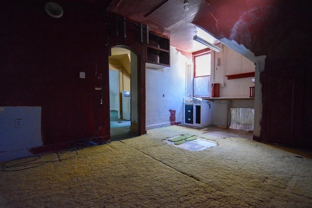 unfurnished room featuring baseboards and carpet