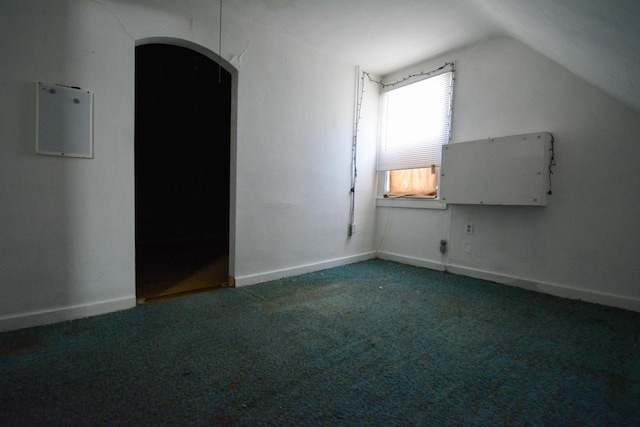 bonus room with lofted ceiling, baseboards, carpet floors, and arched walkways