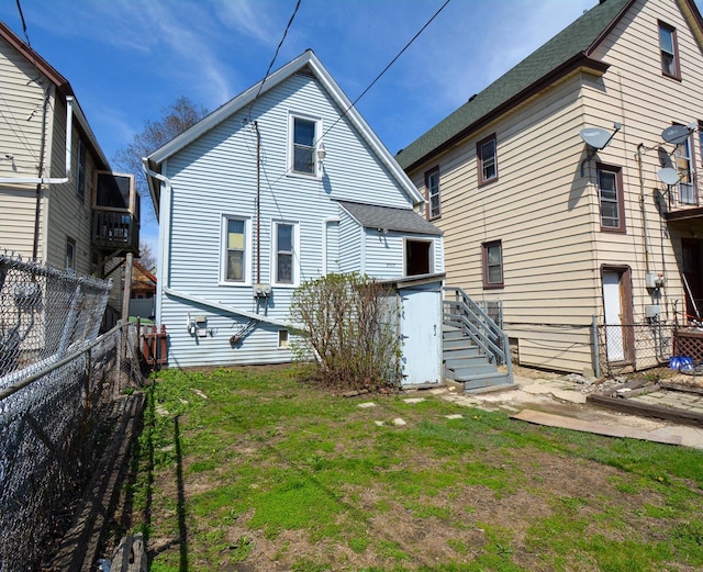 rear view of house featuring a fenced backyard