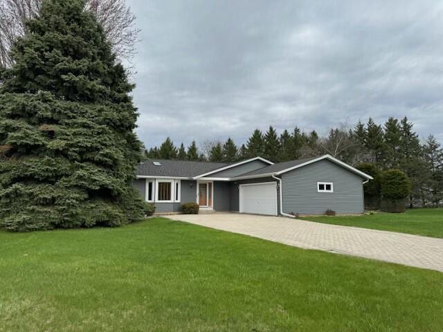 ranch-style home with a front lawn, driveway, and a garage