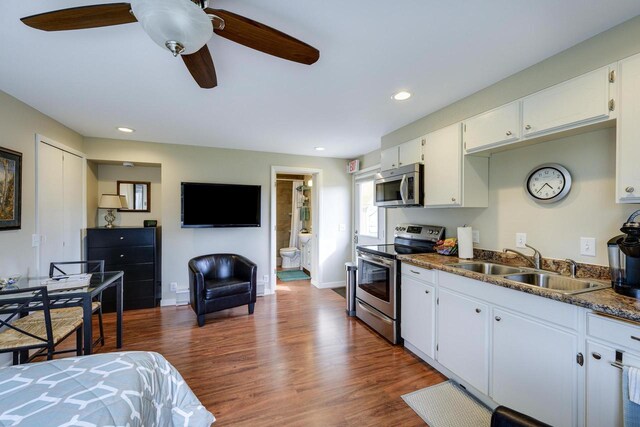 229 N Ludington St, Columbus, WI 53925 - kitchen with a sink, appliances with stainless steel finishes, white cabinetry, and dark wood-type flooring