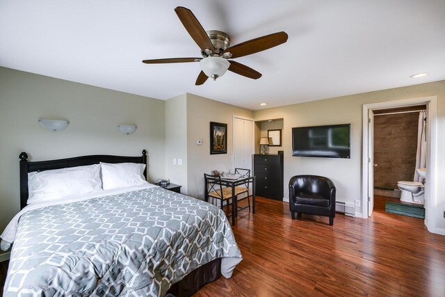 229 N Ludington St, Columbus, WI 53925 - bedroom with wood finished floors, baseboards, ceiling fan, a baseboard radiator, and ensuite bath