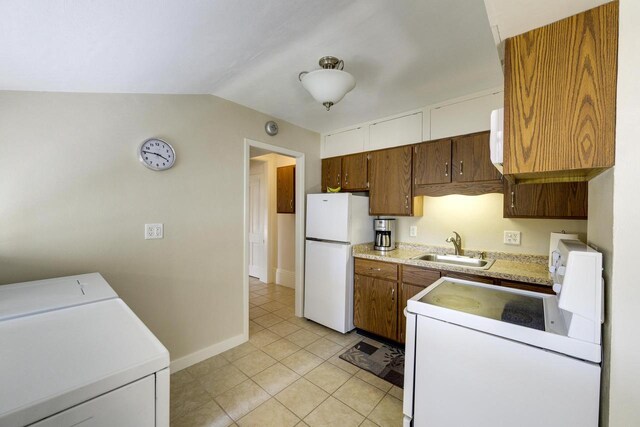 229 N Ludington St, Columbus, WI 53925 - kitchen featuring white appliances, baseboards, light countertops, brown cabinets, and a sink