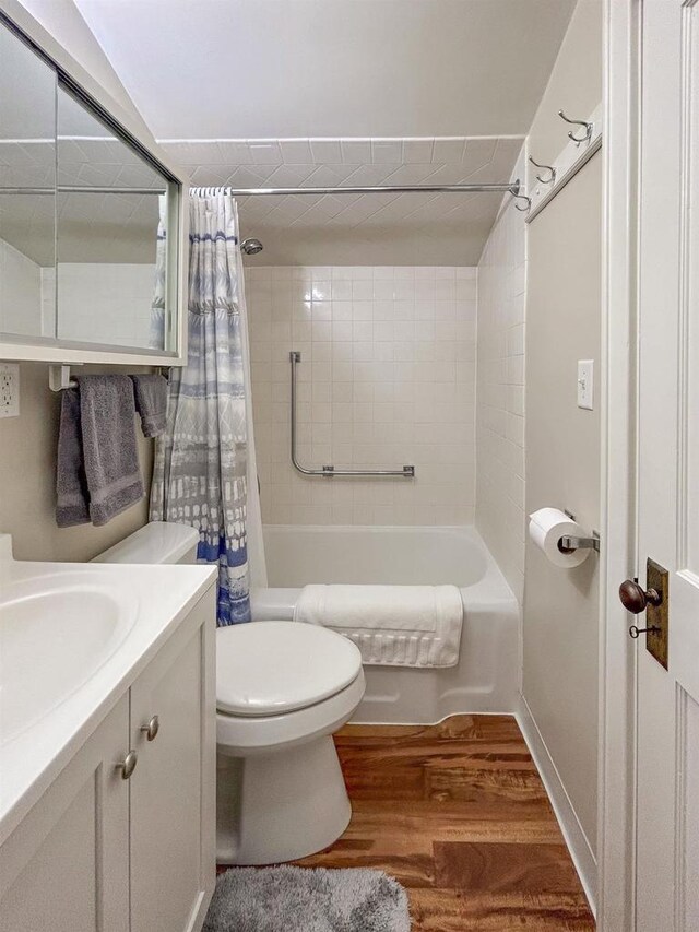 229 N Ludington St, Columbus, WI 53925 - full bathroom with vanity, toilet, wood finished floors, and shower / bath combination with curtain