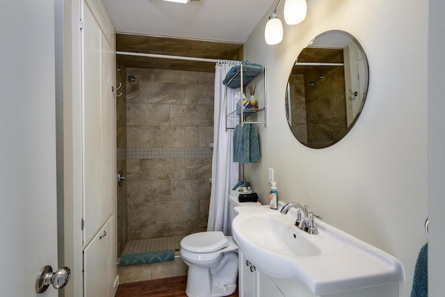 229 N Ludington St, Columbus, WI 53925 - bathroom featuring vanity, toilet, and tiled shower