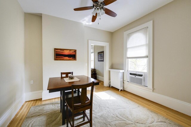 229 N Ludington St, Columbus, WI 53925 - dining area with light wood-style floors, radiator, cooling unit, and a ceiling fan