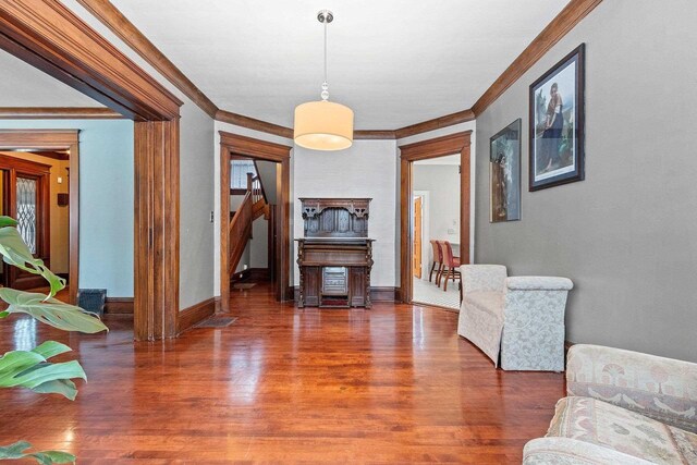 745 S Quincy St, Green Bay, WI 54301 - living area with wood finished floors, ornamental molding, and baseboards