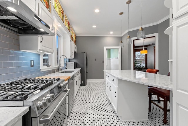 745 S Quincy St, Green Bay, WI 54301 - kitchen featuring white cabinets, a sink, appliances with stainless steel finishes, a breakfast bar, and extractor fan