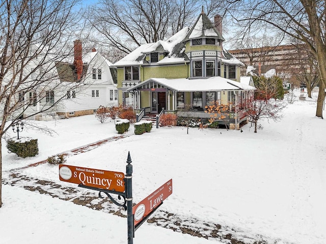 745 S Quincy St, Green Bay, WI 54301 - snow covered house featuring a chimney and covered porch
