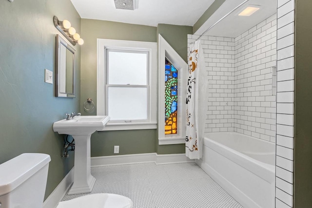 745 S Quincy St, Green Bay, WI 54301 - full bath with shower / tub combo, visible vents, baseboards, toilet, and tile patterned floors