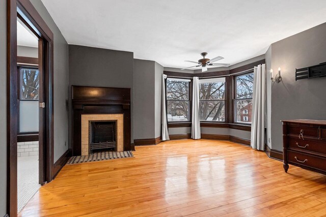 745 S Quincy St, Green Bay, WI 54301 - unfurnished living room with baseboards, ceiling fan, a wealth of natural light, and light wood finished floors