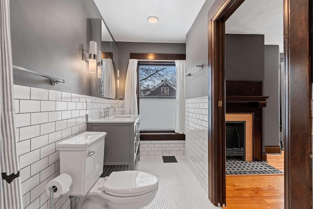 745 S Quincy St, Green Bay, WI 54301 - bathroom with tile walls, visible vents, toilet, and vanity