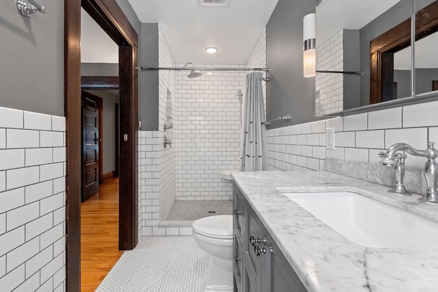 745 S Quincy St, Green Bay, WI 54301 - full bath featuring a shower stall, visible vents, toilet, tile walls, and vanity