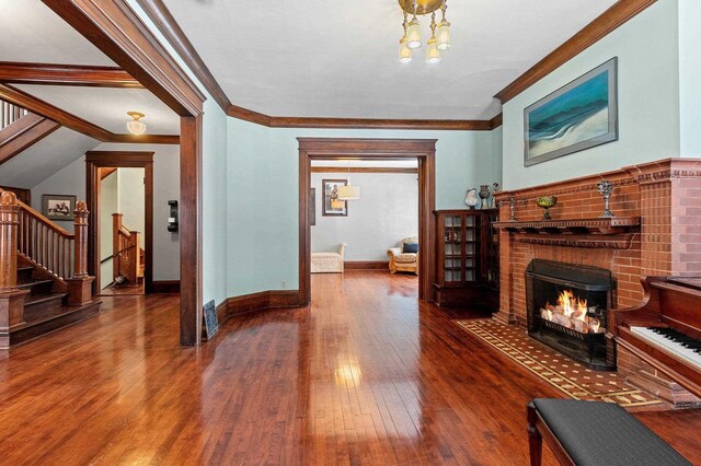 745 S Quincy St, Green Bay, WI 54301 - living room with crown molding, stairs, hardwood / wood-style floors, and a fireplace