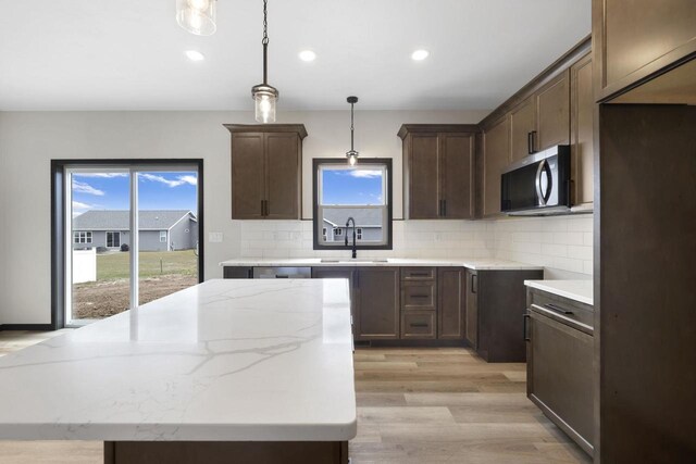 2081 Antelope Trl, Kaukauna, WI 54130 - kitchen with tasteful backsplash, stainless steel appliances, dark brown cabinets, and a sink