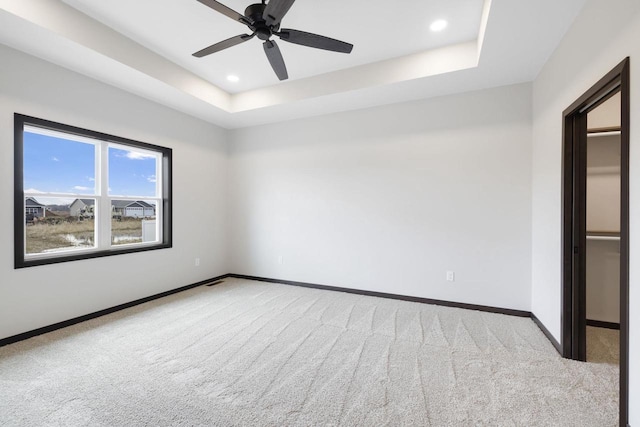 2081 Antelope Trl, Kaukauna, WI 54130 - unfurnished bedroom featuring a tray ceiling, carpet flooring, recessed lighting, and baseboards
