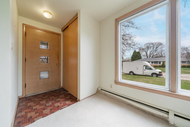 167 Gwynn St, Green Bay, WI 54301 - interior space featuring baseboards, a baseboard heating unit, and plenty of natural light