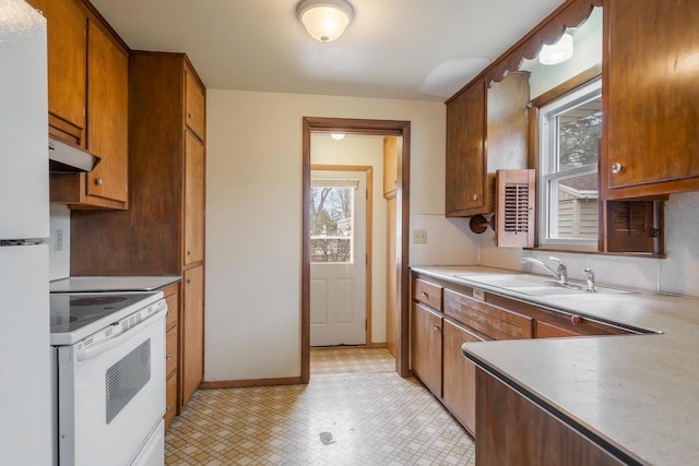 167 Gwynn St, Green Bay, WI 54301 - kitchen featuring a wealth of natural light, white appliances, light countertops, and a sink