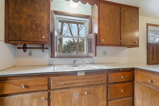 167 Gwynn St, Green Bay, WI 54301 - kitchen with a sink, brown cabinets, and light countertops