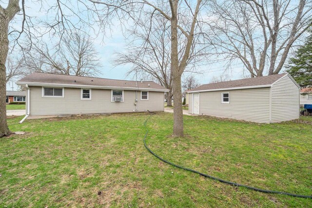 167 Gwynn St, Green Bay, WI 54301 - rear view of house with a lawn and an outdoor structure