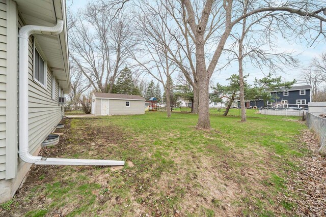 167 Gwynn St, Green Bay, WI 54301 - view of yard featuring fence and an outbuilding