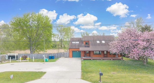 N7315 Winnebago Dr, Fond Du Lac, WI 54935 - log home with driveway, covered porch, and a shingled roof