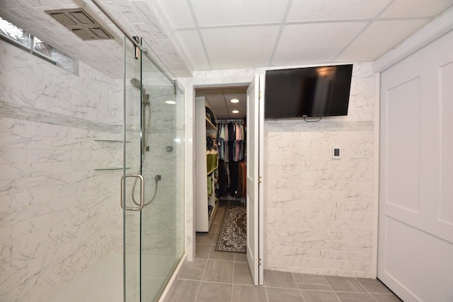 full bathroom featuring a spacious closet and a stall shower