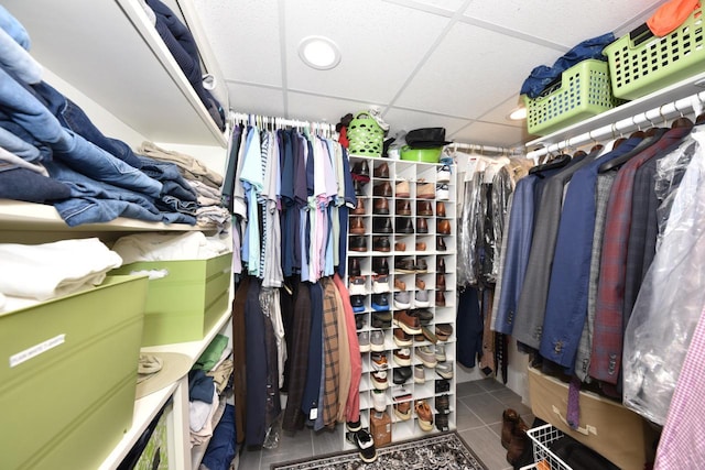 spacious closet with tile patterned floors and a paneled ceiling