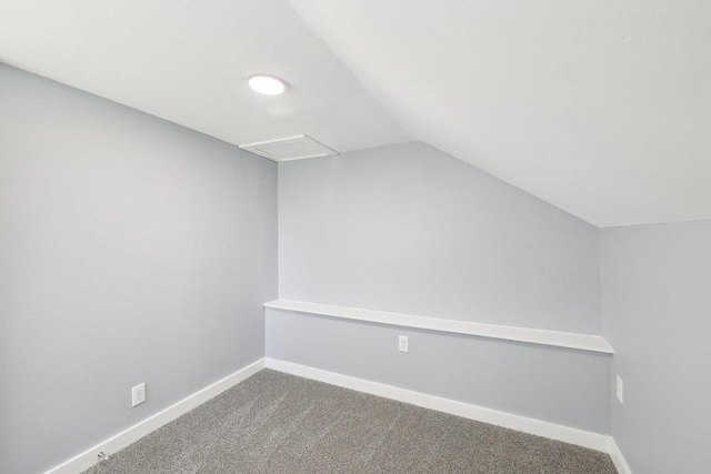 additional living space featuring baseboards, vaulted ceiling, and carpet