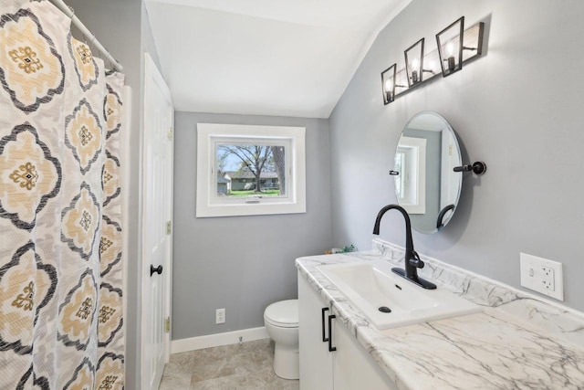 bathroom with a shower with curtain, vaulted ceiling, vanity, baseboards, and toilet
