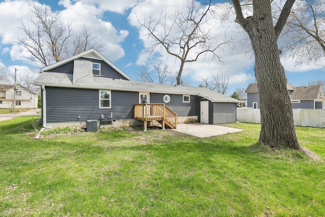 rear view of house featuring a yard, a patio, fence, and central AC unit