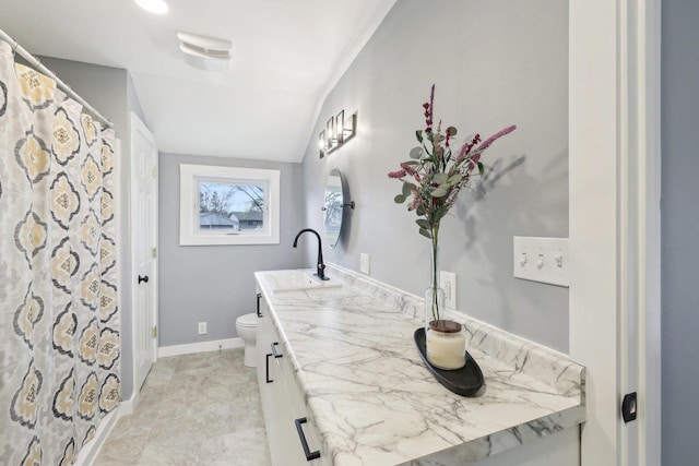 full bath featuring vanity, baseboards, and toilet