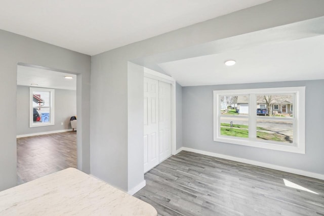 bedroom featuring baseboards, a closet, and wood finished floors