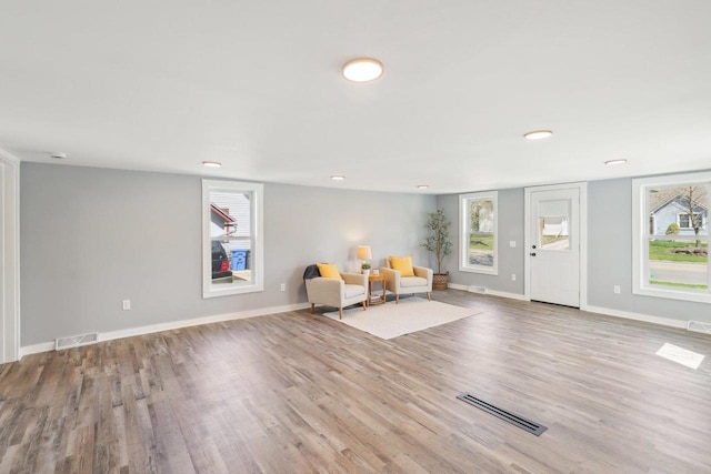 entryway with visible vents, baseboards, and wood finished floors