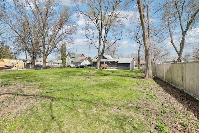 view of yard featuring fence and a residential view