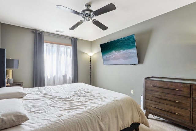 carpeted bedroom featuring visible vents and ceiling fan