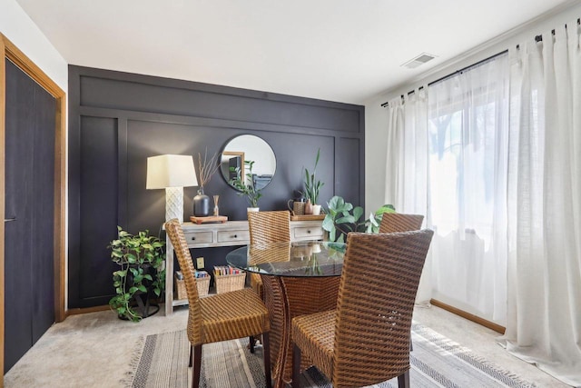 dining area with visible vents and light carpet